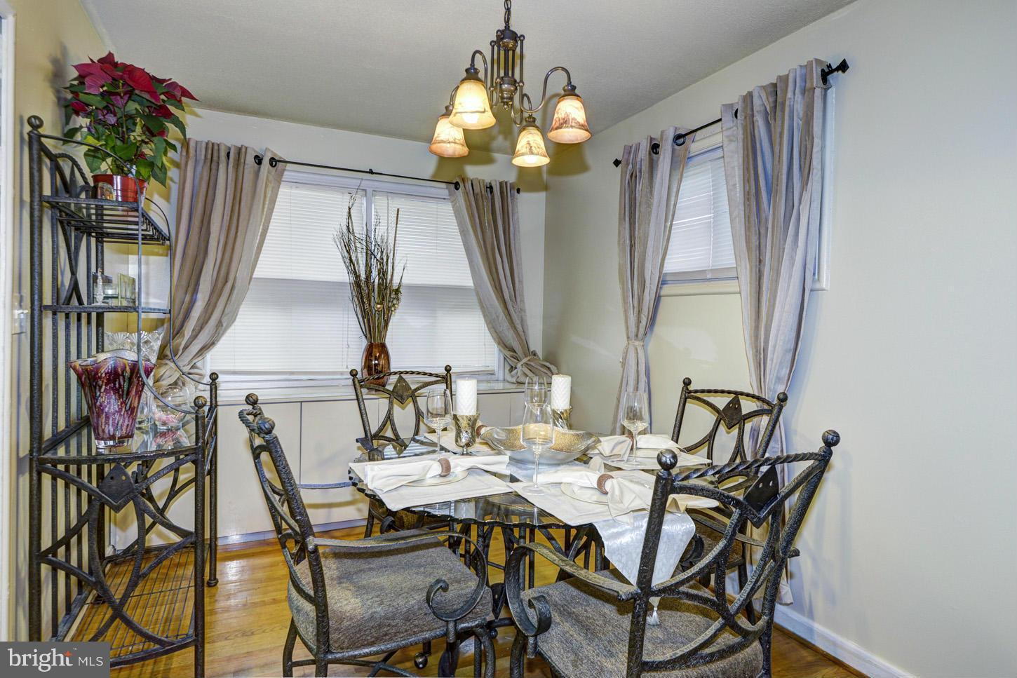 7415 Sudbrook Road Baltimore, MD 21208 - Photo 5 of 13 a view of a dining room with furniture and chandelier