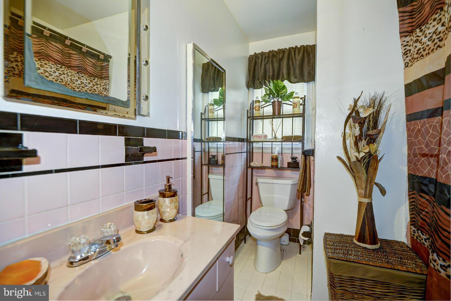7415 Sudbrook Road Baltimore, MD 21208 - Photo 6 of 13 a bathroom with a sink toilet and shower