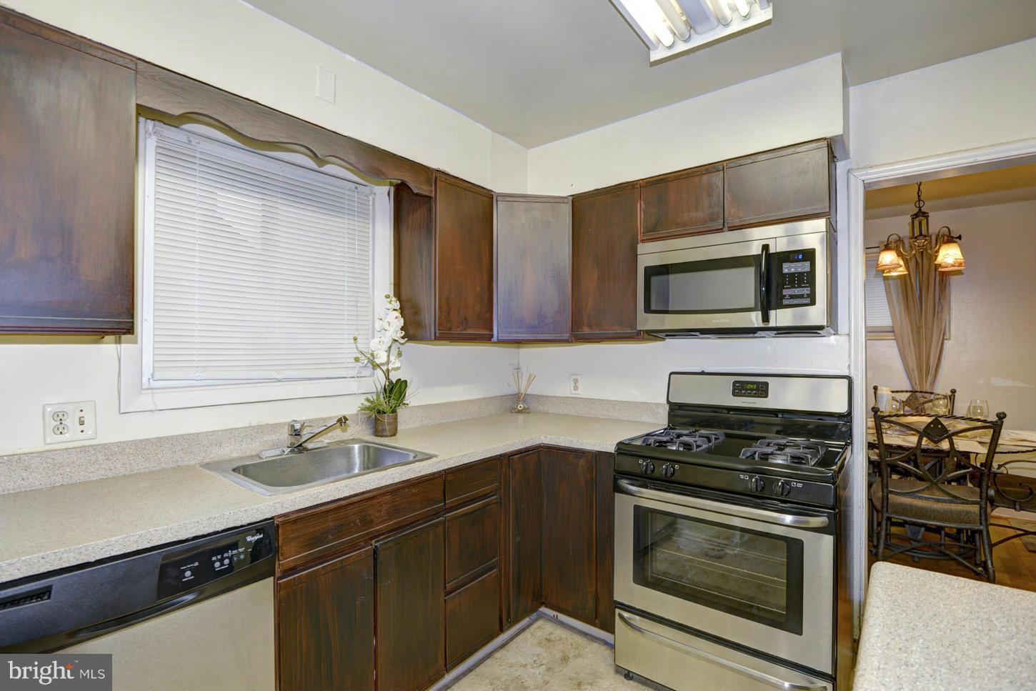 7415 Sudbrook Road Baltimore, MD 21208 - Photo 7 of 13 a kitchen with a sink stove and microwave