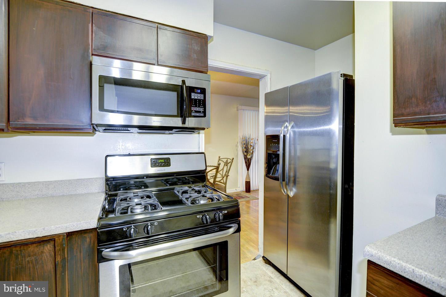 7415 Sudbrook Road Baltimore, MD 21208 - Photo 9 of 13 a kitchen with a stove and a microwave