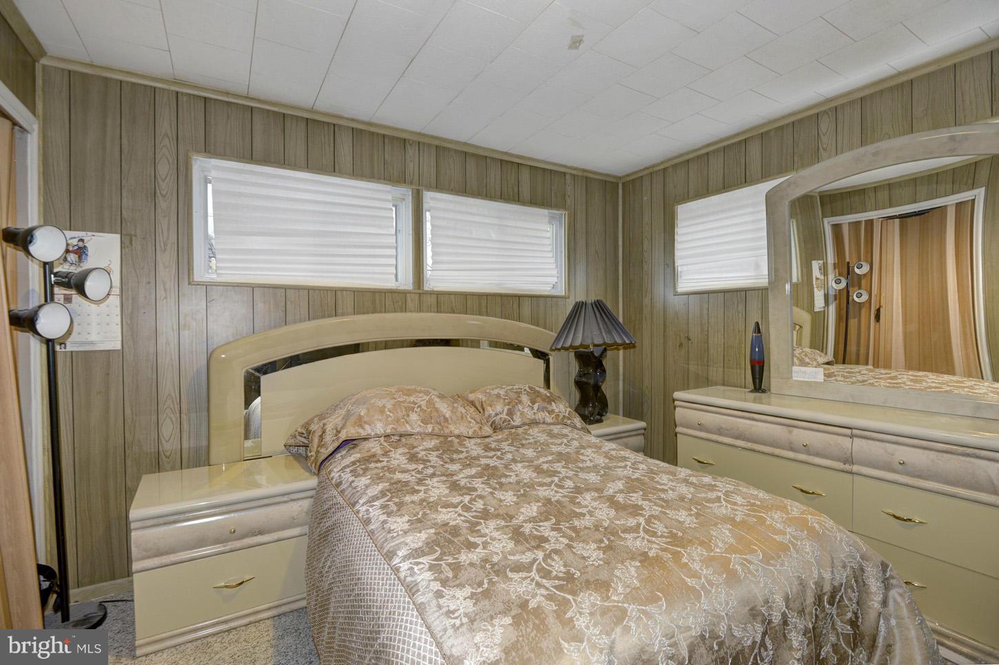 7415 Sudbrook Road Baltimore, MD 21208 - Photo 10 of 13 a bed sitting in a bedroom next to a window