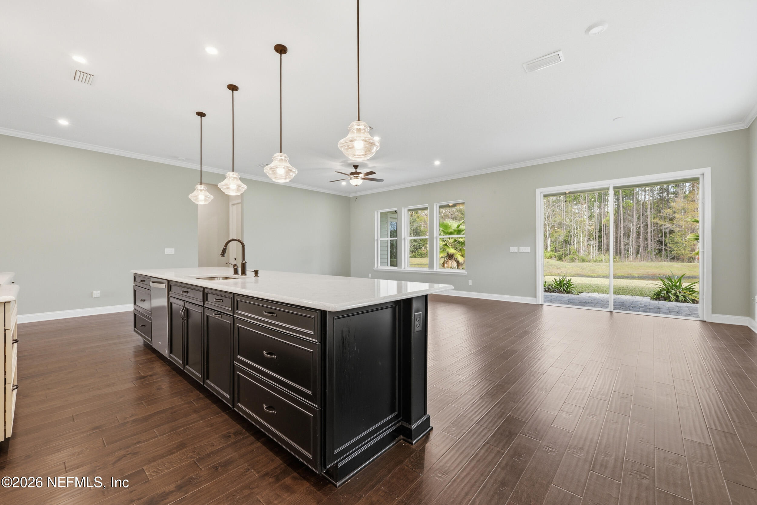 130 Key Grass Court St. Johns, FL 32259 - Photo 18 of 95 a kitchen with stainless steel appliances granite countertop a stove a sink dishwasher and a large window with wooden floor