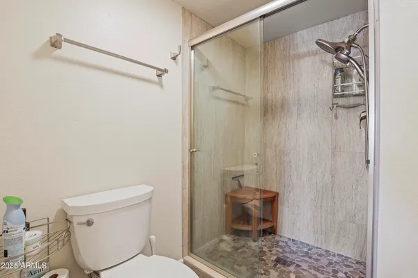 a white toilet sitting next to a bathroom sink