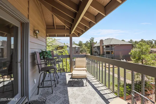 a view of a porch with chairs and backyard