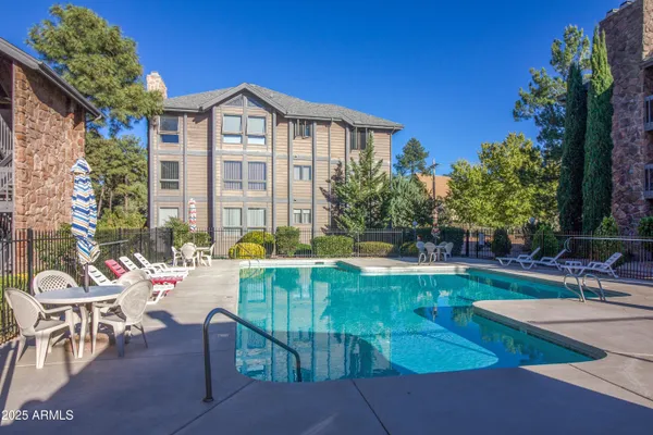 a view of a house with swimming pool and sitting area