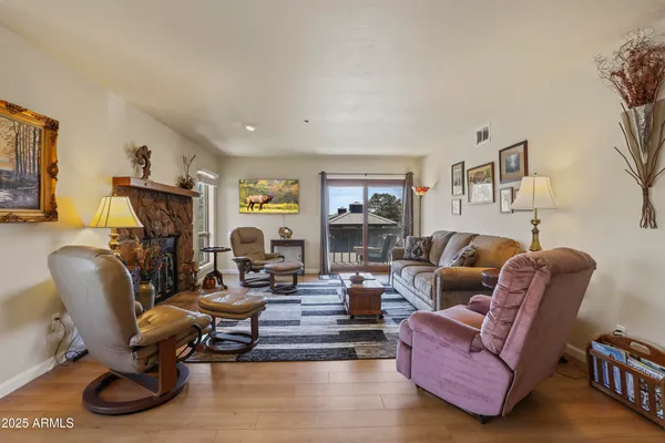 a living room with furniture a fireplace and a window