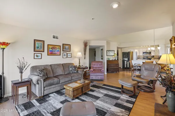 a living room with furniture wooden floor and a table