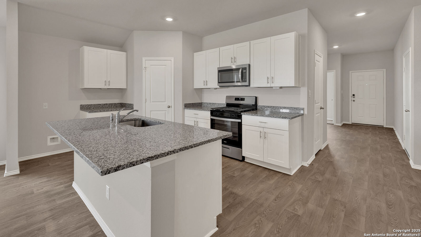 322 Hodges Street Maxwell, TX 78656 - Photo 13 of 34 a kitchen with stainless steel appliances granite countertop a stove a sink and a microwave