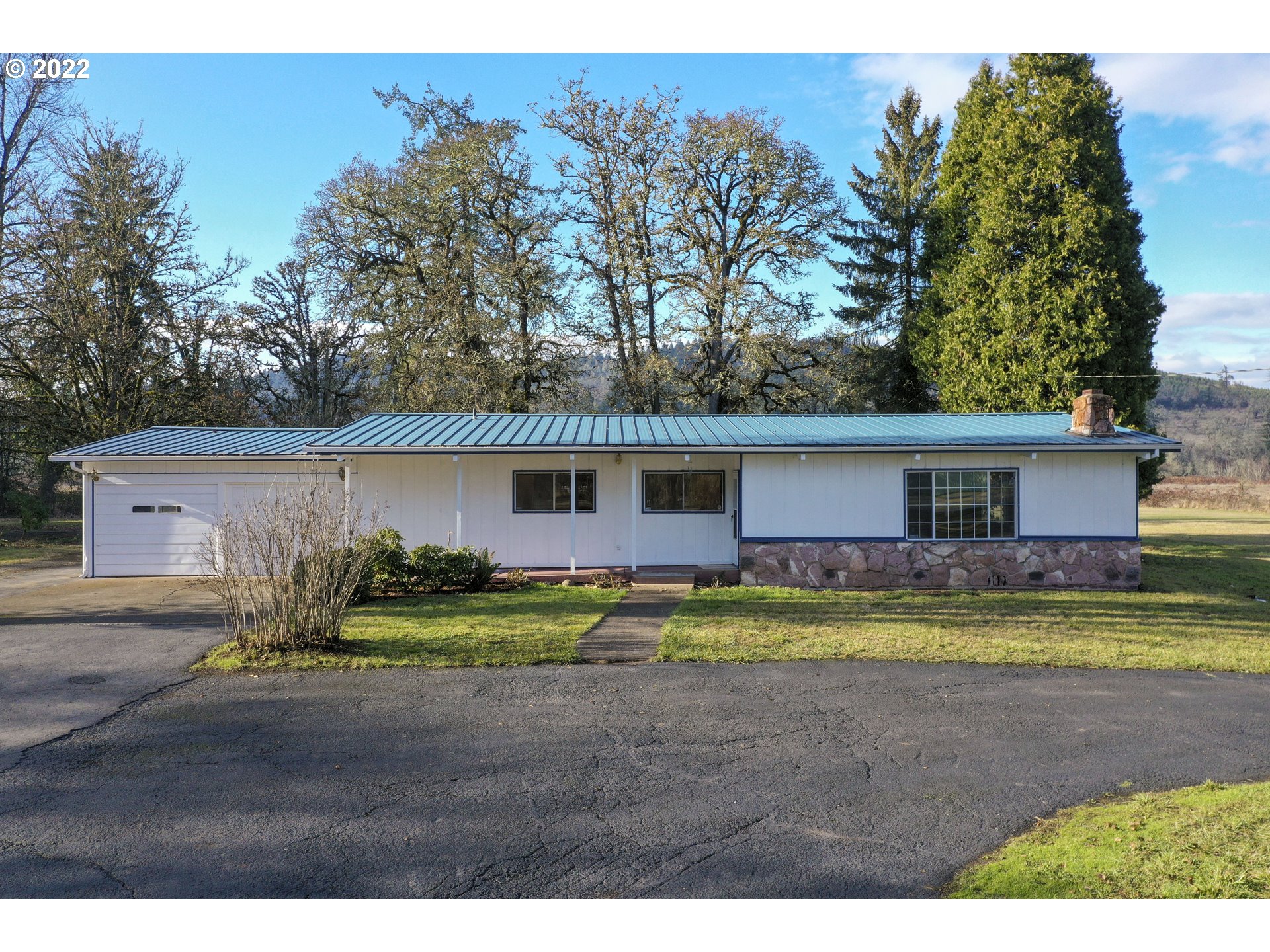 84926 Cloverdale Road Creswell, OR 97426 - Photo 2 of 31 a view of a yard in front of a house with a large tree