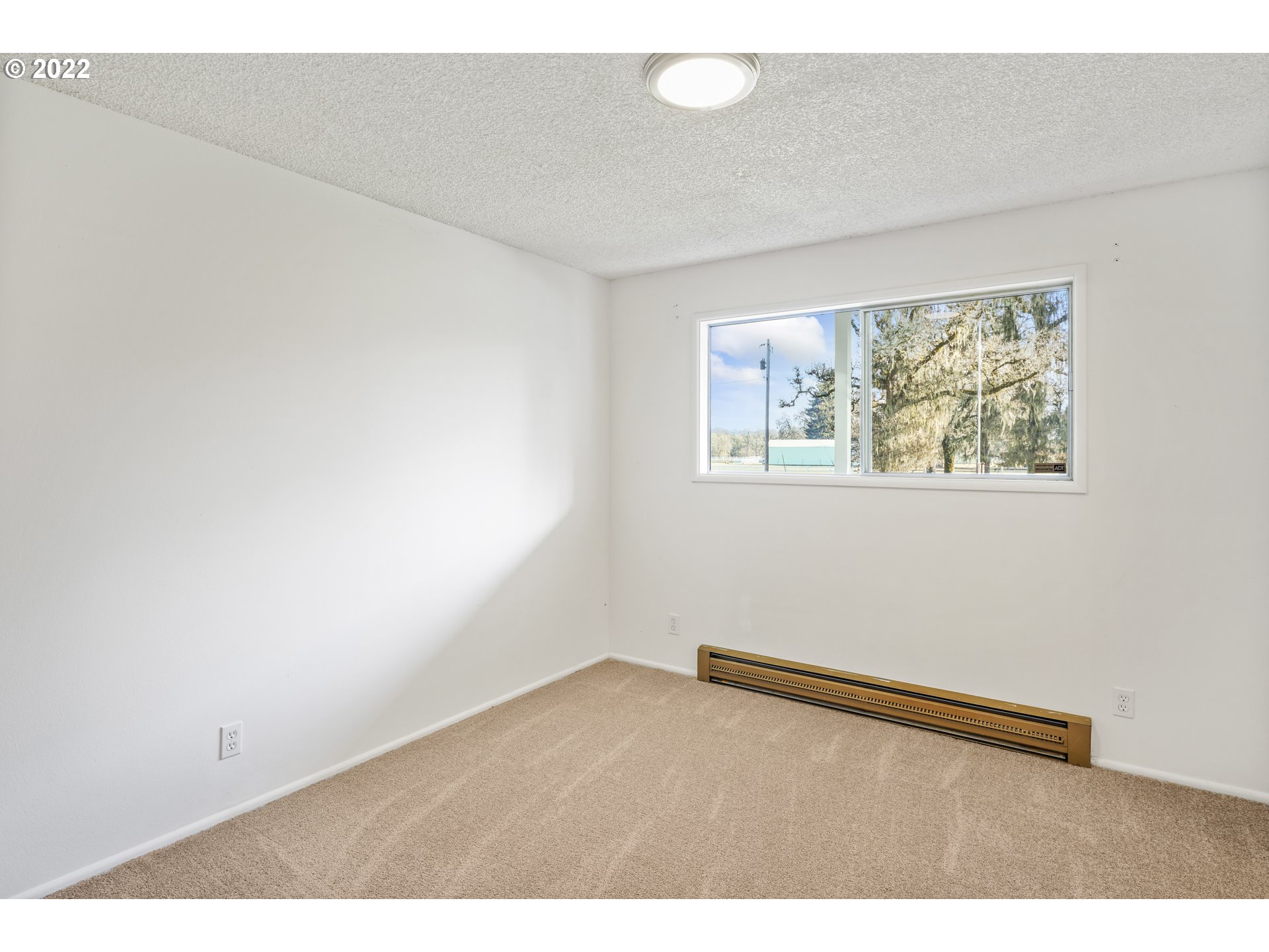 84926 Cloverdale Road Creswell, OR 97426 - Photo 23 of 31 an empty room with wooden floor and windows