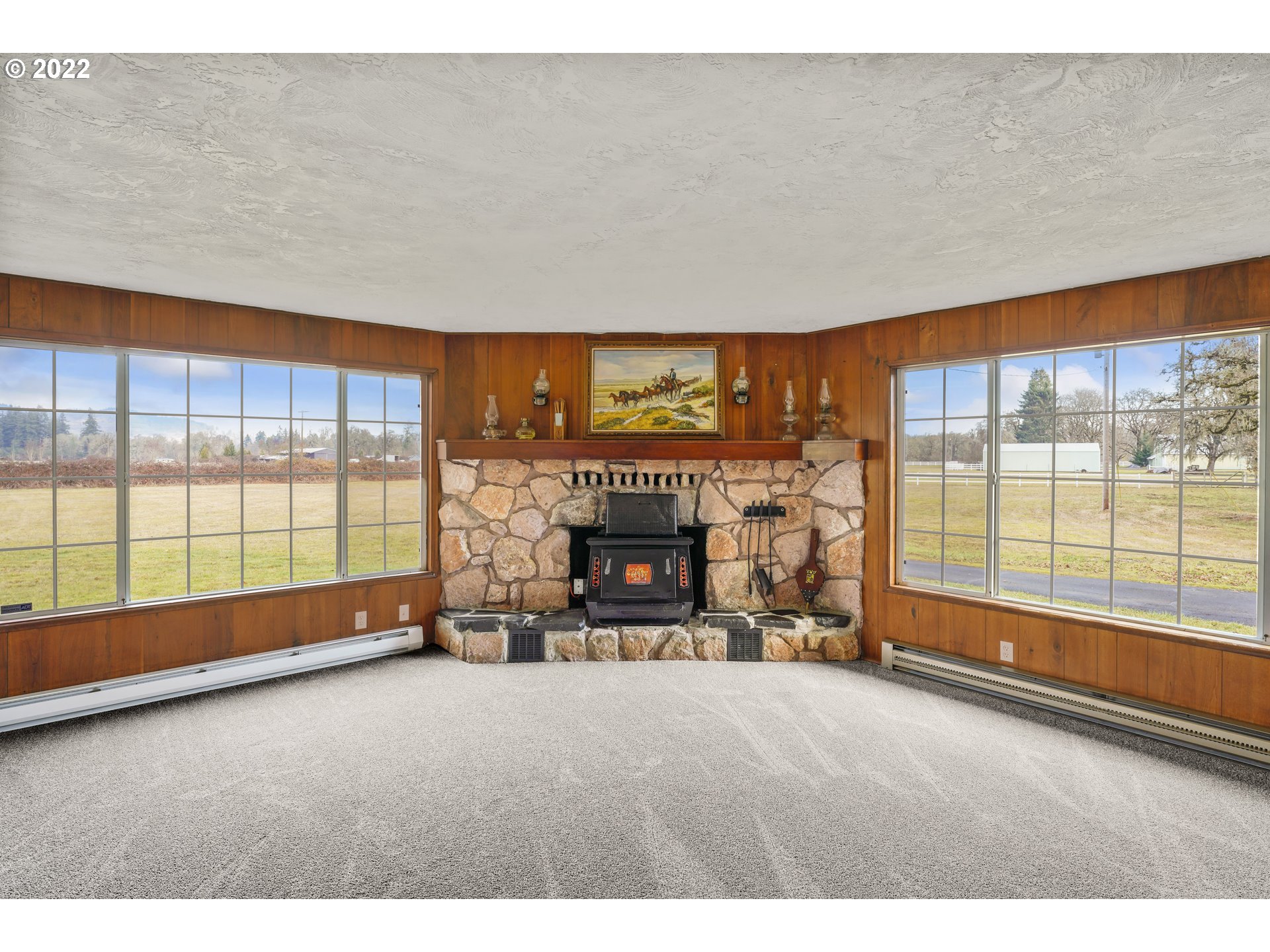 84926 Cloverdale Road Creswell, OR 97426 - Photo 6 of 31 a view of an empty room with a fireplace and a large window