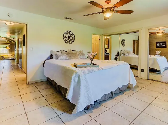 a bedroom with a bed and ceiling fan
