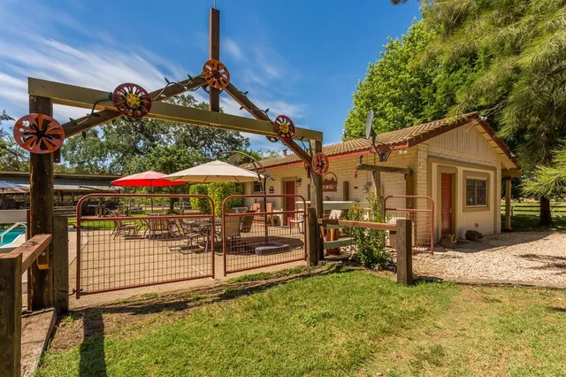 a view of a backyard with swimming pool