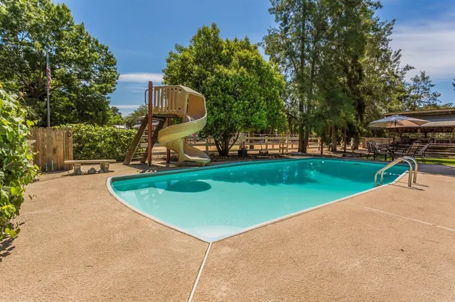 a patio with a table and chairs under an umbrella