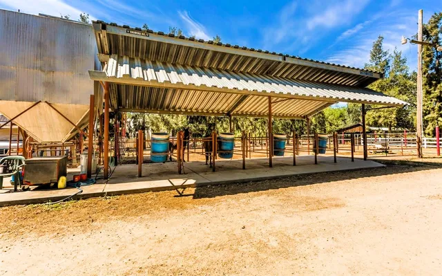 a view of a patio with table and chairs under an umbrella