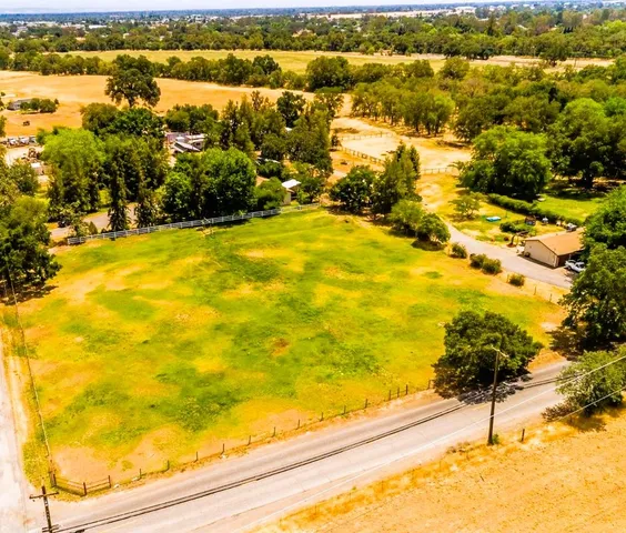 an aerial view of a house with a yard and garden