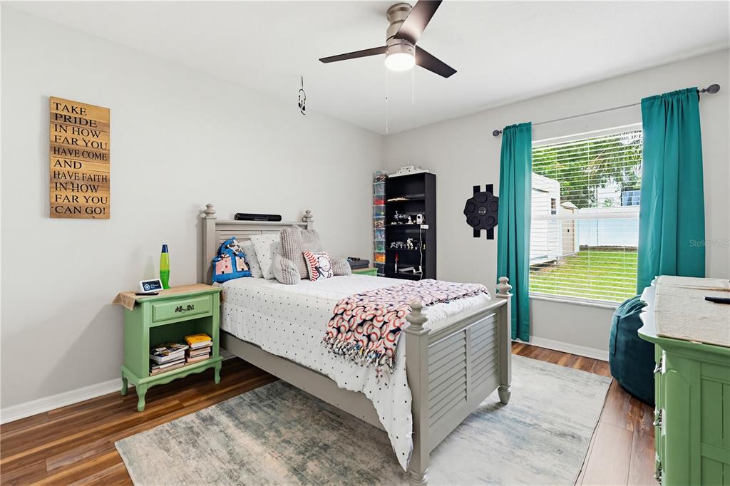 3497 Chadwick Avenue Spring Hill, FL 34609 - Photo 30 of 47 a bedroom with a bed and a chandelier