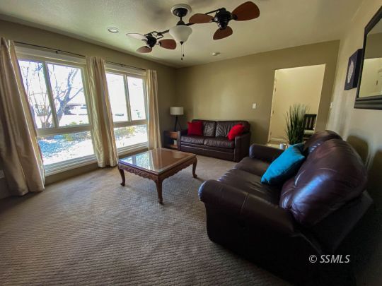 218 South Lilac Street Ridgecrest, CA 93555 - Photo 9 of 43 a living room with furniture and a window
