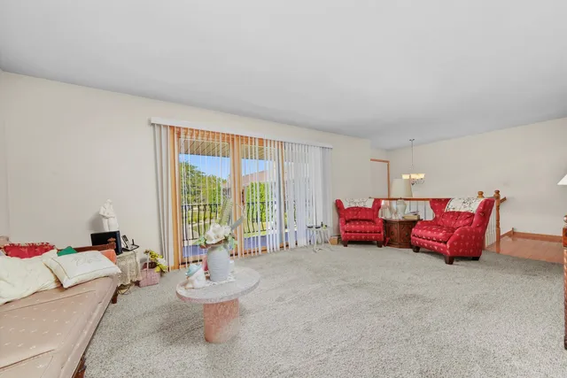 a living room with furniture and a floor to ceiling window