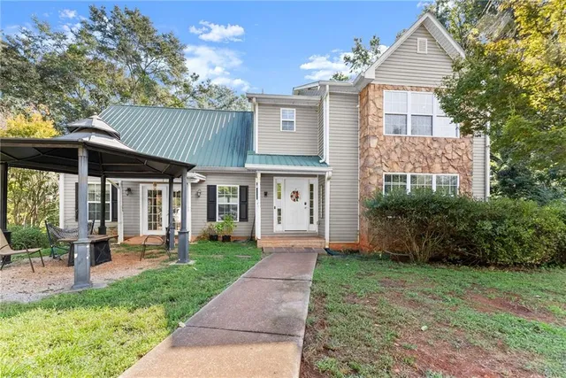 a front view of a house with garden