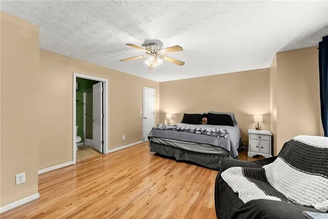 a bedroom with a bed and a television