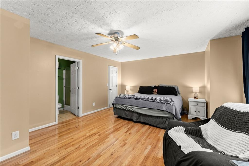 7540 County Line Road Lula, GA 30554 - Photo 11 of 64 a spacious bedroom with a bed and wooden floor