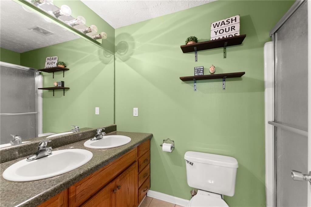 7540 County Line Road Lula, GA 30554 - Photo 13 of 64 a bathroom with a toilet sink and mirror