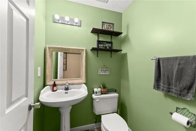 a kitchen with stainless steel appliances wooden floor and a large window