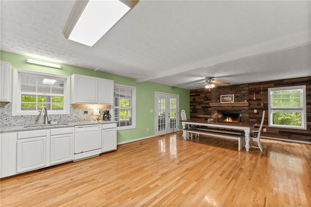 7540 County Line Road Lula, GA 30554 - Photo 16 of 64 a kitchen with stainless steel appliances wooden floor and a large window