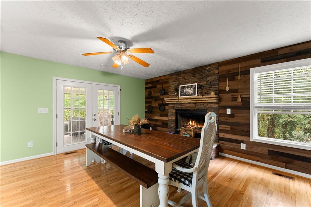 7540 County Line Road Lula, GA 30554 - Photo 17 of 64 a living room with furniture a fireplace and a large window