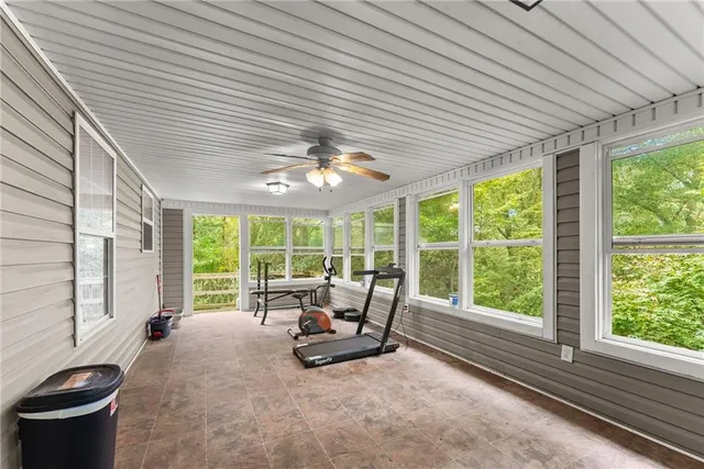 a living room with furniture large window and flat screen tv