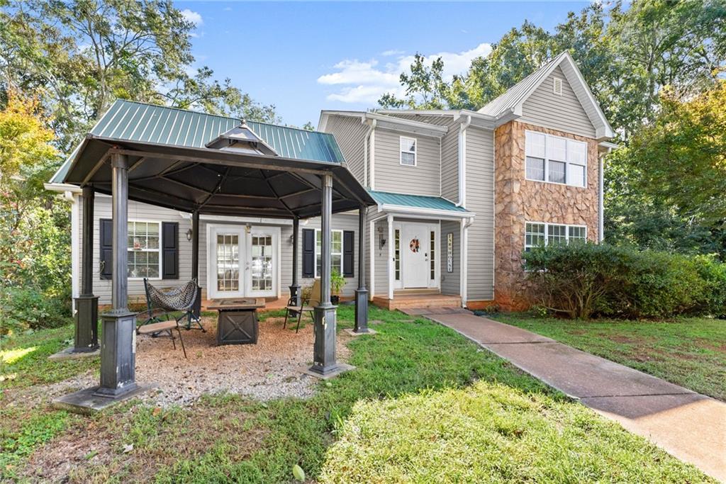 7540 County Line Road Lula, GA 30554 - Photo 2 of 64 a view of a house with a porch and furniture