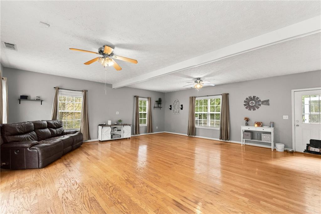 7540 County Line Road Lula, GA 30554 - Photo 21 of 64 a living room with furniture and a wooden floor