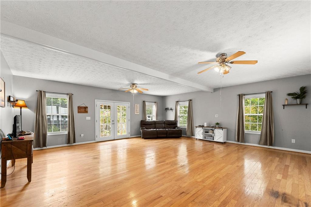 7540 County Line Road Lula, GA 30554 - Photo 23 of 64 a view of a livingroom with furniture hardwood floor and a ceiling fan