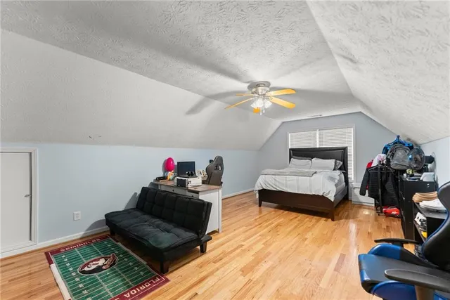 a bedroom with furniture and a wooden floor