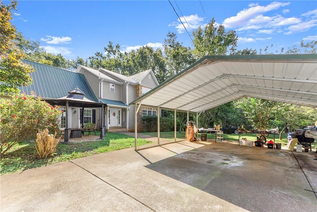 7540 County Line Road Lula, GA 30554 - Photo 3 of 64 a view of a building with a patio and a yard