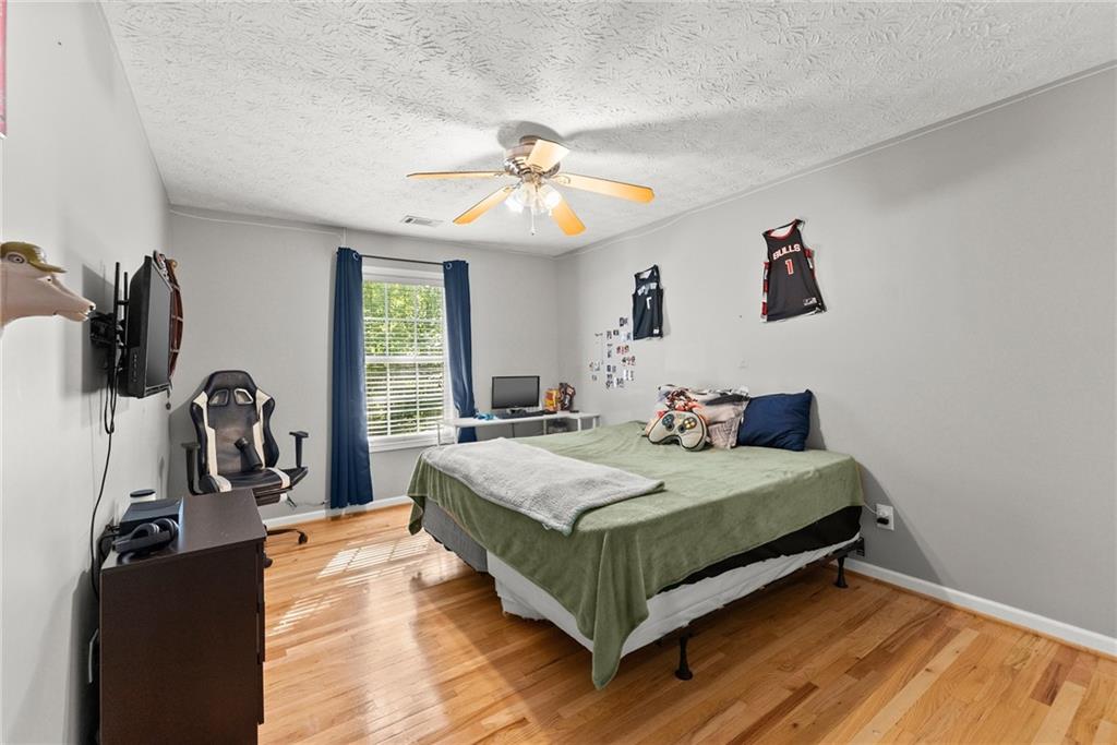 7540 County Line Road Lula, GA 30554 - Photo 31 of 64 a bedroom with a bed and a flat tv screen on the dresser