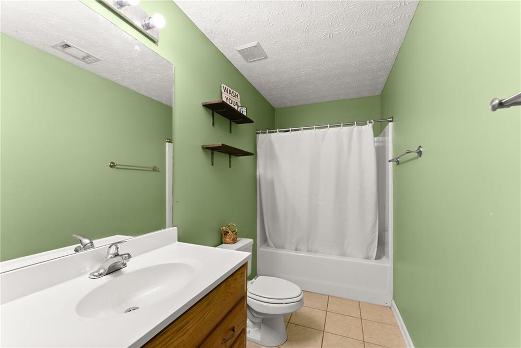 7540 County Line Road Lula, GA 30554 - Photo 33 of 64 a bathroom with a sink toilet and shower