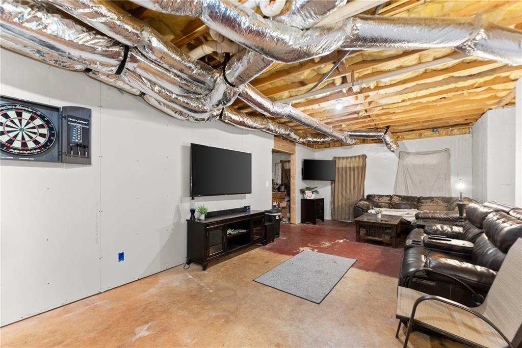 7540 County Line Road Lula, GA 30554 - Photo 34 of 64 a living room with furniture and a flat screen tv