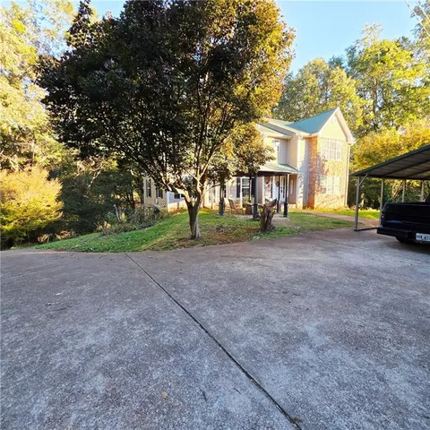 a view of road with yard and trees around