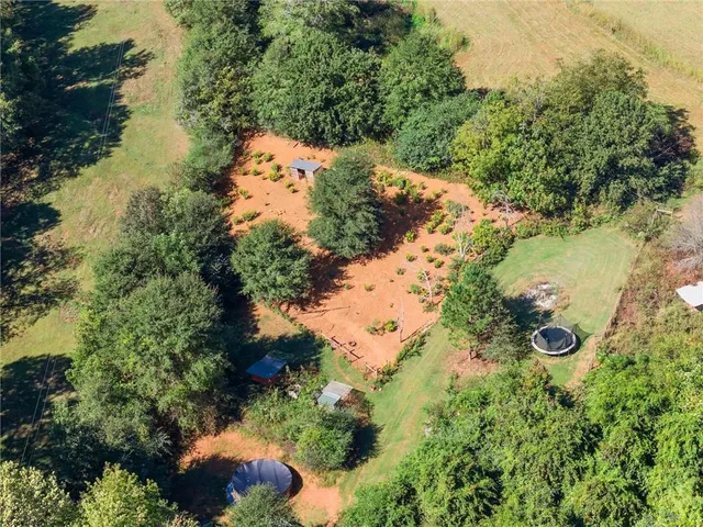 an aerial view of a houses with a yard