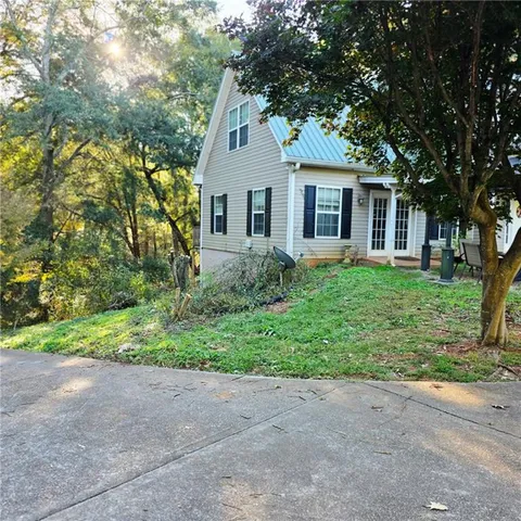 a front view of house with yard and green space