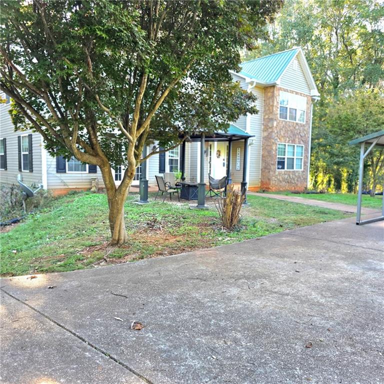7540 County Line Road Lula, GA 30554 - Photo 8 of 64 a front view of a house with a yard and trees