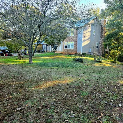 a view of a house with a yard