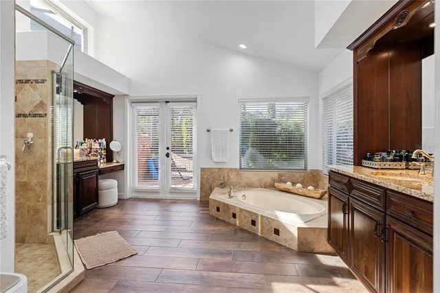 a large spacious bathroom with a large tub shower and sink