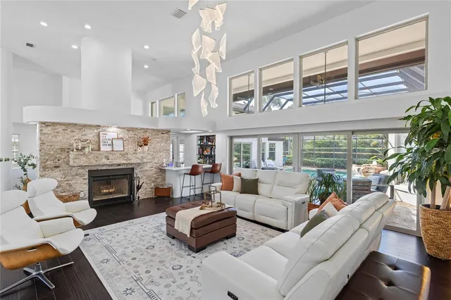 a living room with furniture fireplace and a large window