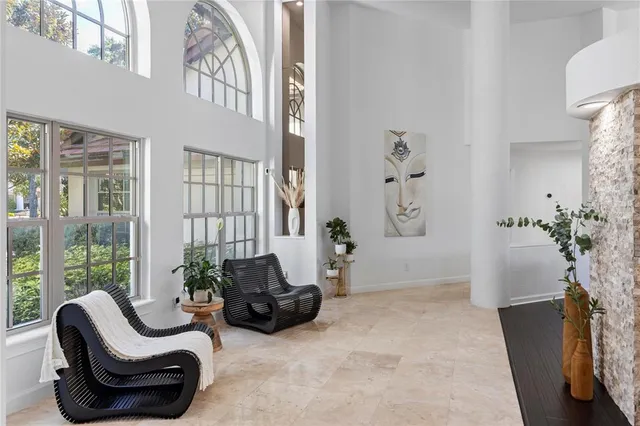 a living room with furniture and a floor to ceiling window