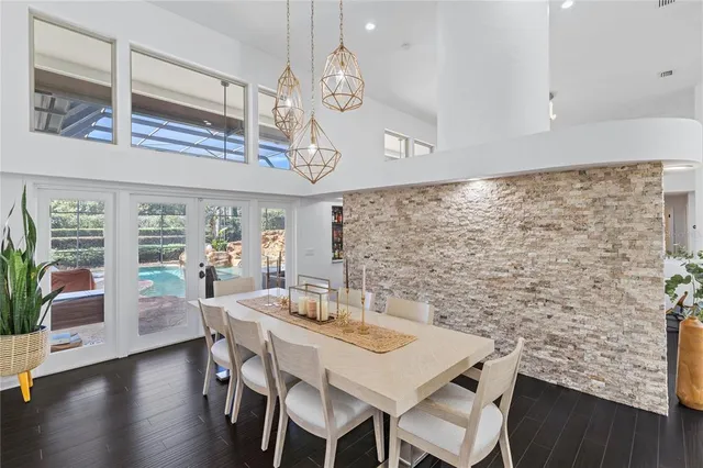 a view of a dining room with furniture a chandelier and wooden floor