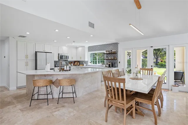 a dining room with furniture and window