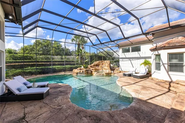 a view of a house with backyard and sitting area